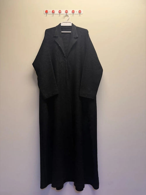 A&M FANCY STORE black textured maxi dress with embellished lapel collar and long sleeves. Flowing silhouette for elegant, modest style.