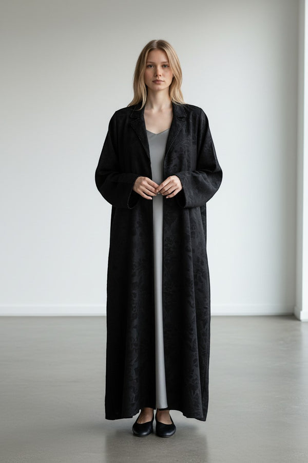 A&M FANCY STORE black textured maxi dress with embellished lapel collar and long sleeves, flowing silhouette.