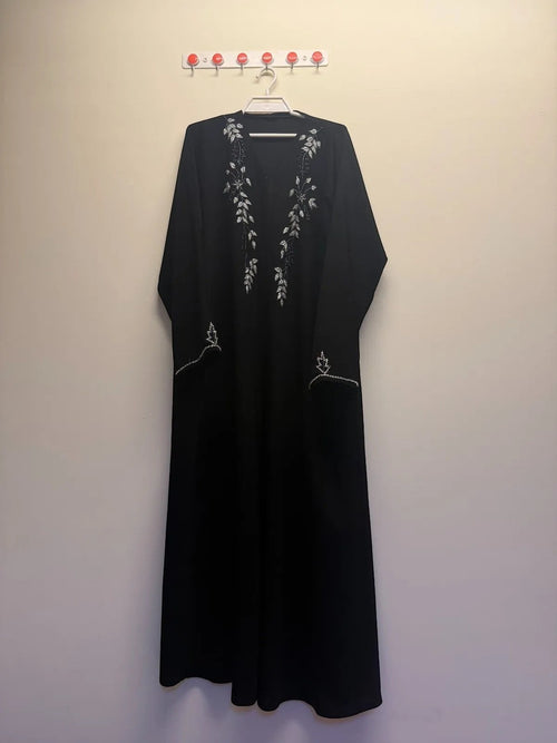 A&M FANCY STORE black embellished maxi abaya dress with silver leaf embroidery and beadwork on neckline and cuffs.