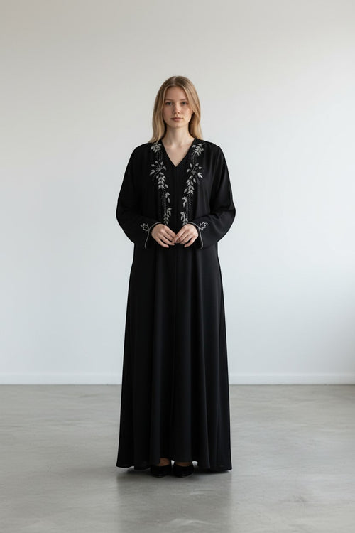 A&M FANCY STORE black abaya with silver leaf embroidery and beadwork on neckline and cuffs. Long sleeve maxi dress.