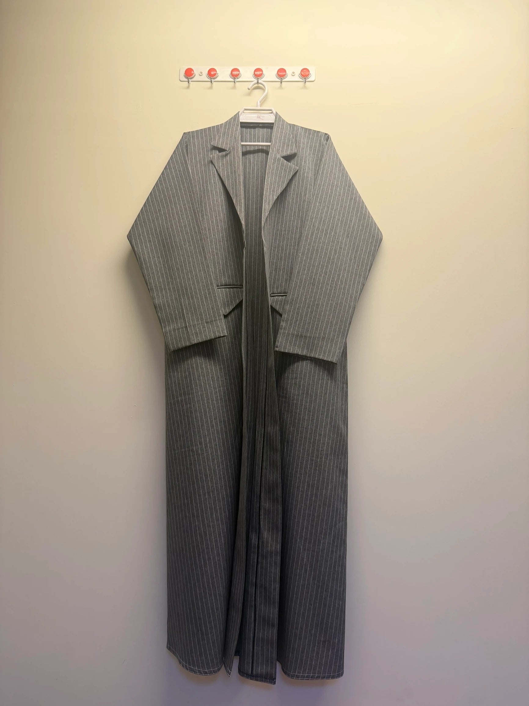 A&M FANCY STORE grey and white pinstripe longline blazer with lapel collar and flowing silhouette.