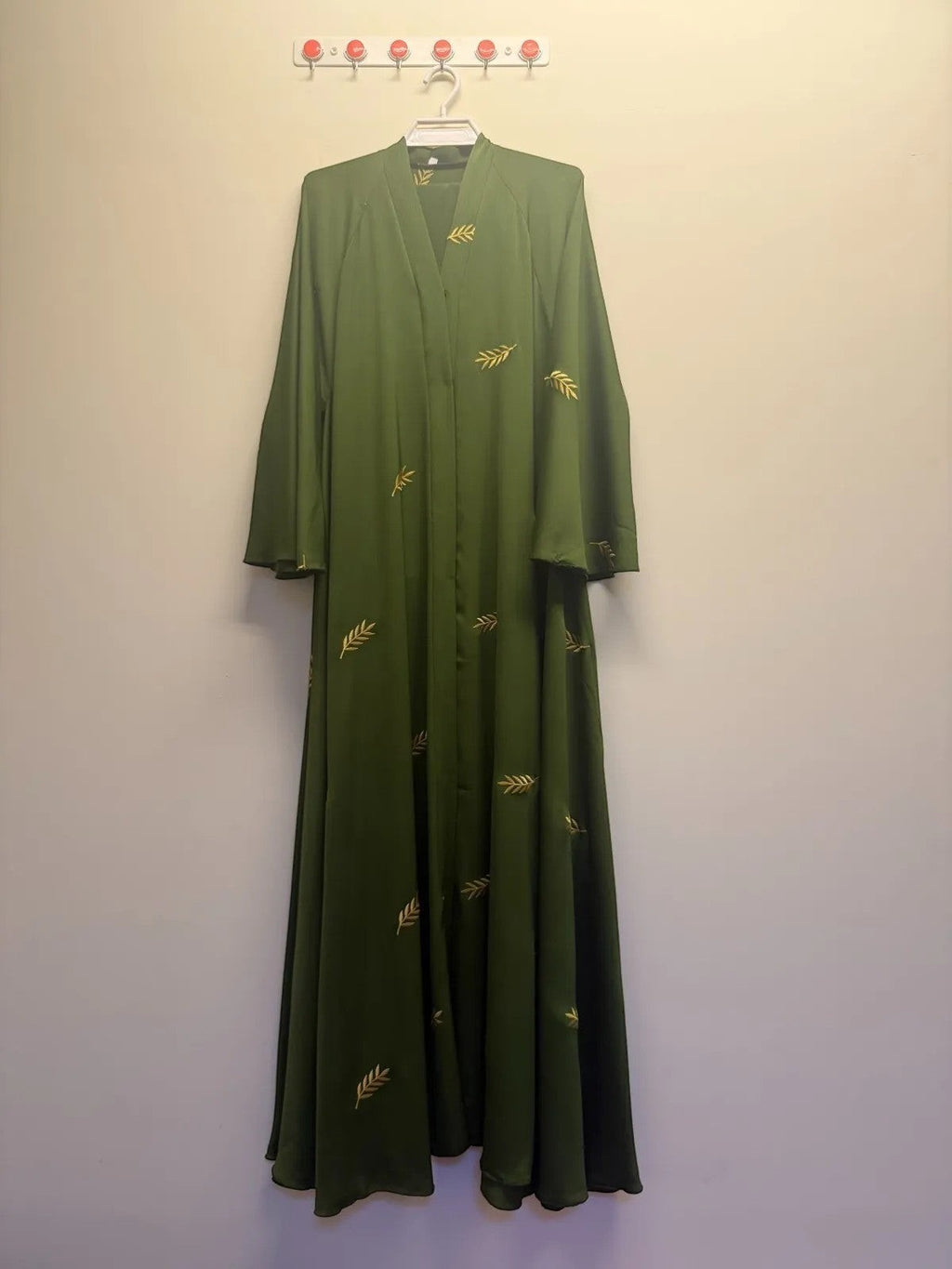 A&M FANCY STORE olive green flowing abaya with gold leaf embroidery, open front, wide sleeves.