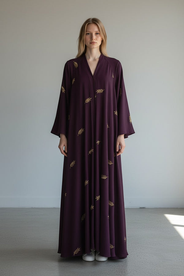 A&M FANCY STORE plum abaya with gold leaf embroidery, V-neck, wide sleeves, and flowing silhouette.
